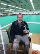 The Secretary holds the trophy